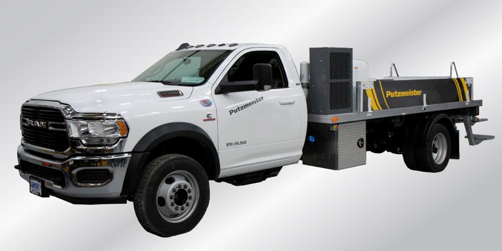 Putzmeister concrete line pump on a white RAM 5500 Heavy Duty chassis